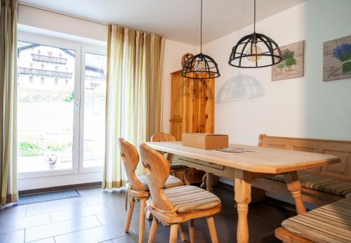 a dining room with a wooden table and chairs at Apartments Drei Türme by Pferd auf Wolke in Schruns-Tschagguns