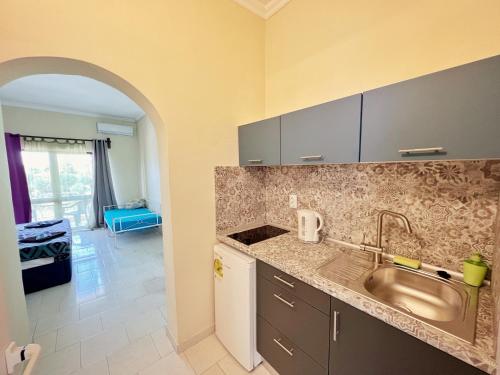a kitchen with a sink and a counter top at Avra Sunset Sea View Liapades in Liapades