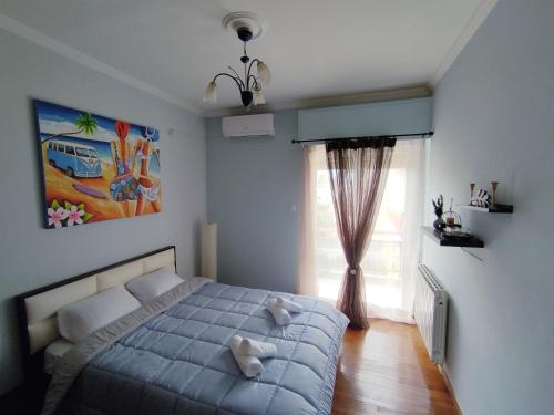 a bedroom with a bed with two teddy bears on it at Sea & Sun - 4th floor comfy apartment, great view in Preveza