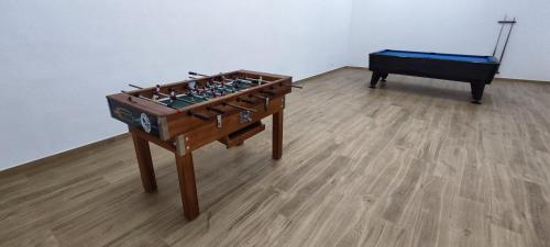 a wooden foosball table and a bed in a room at Casa Almeida in Vimieiro