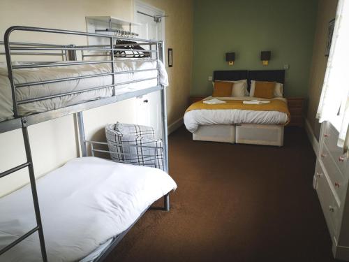 two bunk beds in a room with two beds at George and Abbotsford in Melrose