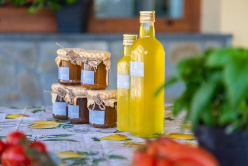 a bottle of honey and jars of jam on a table at ON' MICHELE GUEST HOUSE in Sorrento