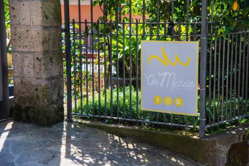 a sign on a iron fence next to a building at ON' MICHELE GUEST HOUSE in Sorrento
