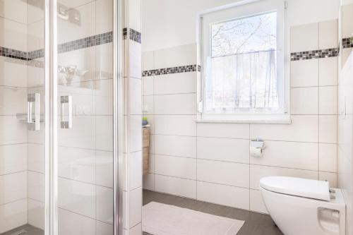 a bathroom with a toilet and a glass shower at Ferienhaus Schlagerbauer Biohof in Salzburg