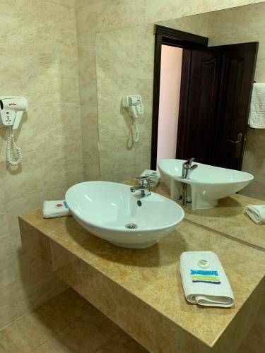 a bathroom with a white sink and a mirror at Laura Holiday in Brăila