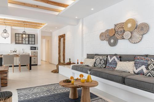 a living room with a couch and a table at Sea & Olives Suites Hotel and Villas in Plaka
