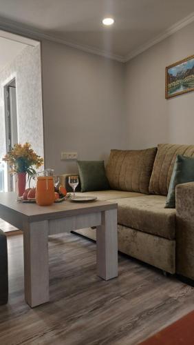 a living room with a couch and a table at Babulya house 2 in Gyumri