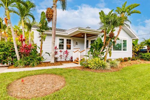 a white house with palm trees in a yard at Siesta Key Island Rentals in Siesta Key