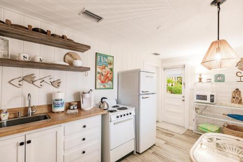 a kitchen with a white refrigerator and a sink at Siesta Key Island Rentals in Siesta Key