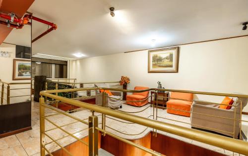 a room with orange chairs and a railing at Recreo Hotel in Trujillo