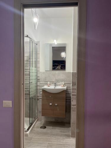 a bathroom with a sink and a mirror at monolocale 2 LudoLeo 5p in Quartu SantʼElena