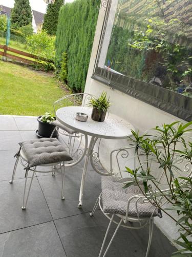 a white table and chairs on a patio at Fewo Faros in Plettenberg