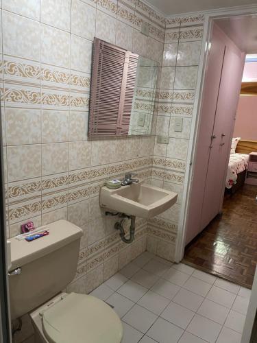 a bathroom with a toilet and a sink at M&M Residence in Baguio
