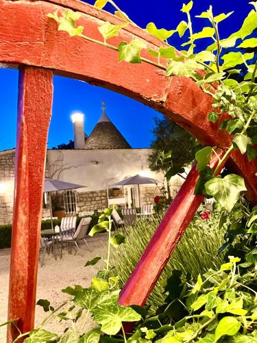 an old red bench with some plants on it at Mirella Charming in Alberobello