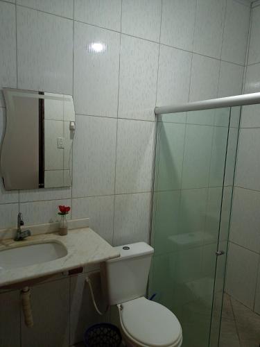 a bathroom with a toilet and a sink and a shower at Camping e Hostel Praia do Saco in Estância