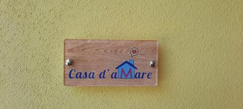 a sign on a wall with the words casa of aame at Casa d'aMare - a 600 mt dalla spiaggia in Follonica
