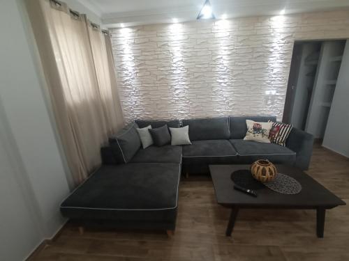 a living room with a couch and a table at MELENIOS HOUSES in Samothráki