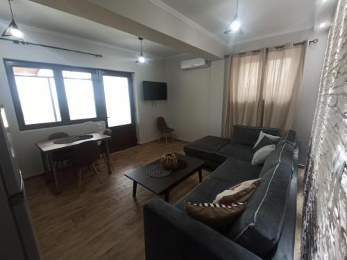 a living room with a couch and a table at MELENIOS HOUSES in Samothráki
