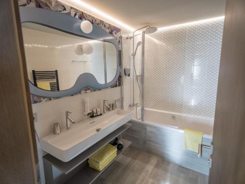 a bathroom with a sink and a mirror at Hotel Kristall in Obertauern