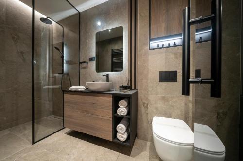 a bathroom with a toilet and a sink and a shower at VELVET rooms & more in Zadar