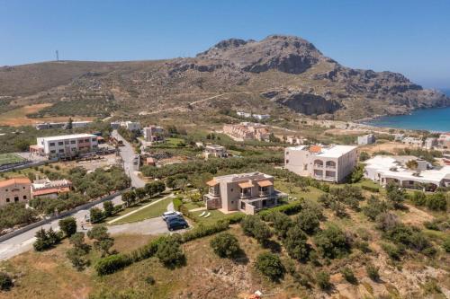 an aerial view of a town with a mountain at Fedra Plakias Apartments in Plakias