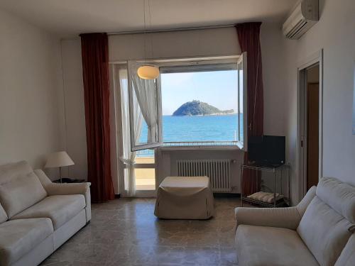 a living room with a large window looking out at the ocean at Residence Sole in Albenga