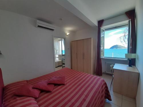 a bedroom with a bed and a large window at Residence Sole in Albenga