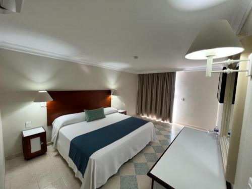 Postel nebo postele na pokoji v ubytování Hotel Sands Arenas
