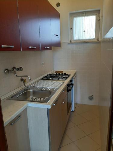 a small kitchen with a sink and a stove at Residence Sole in Albenga