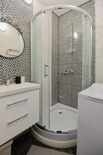 a bathroom with a shower and a toilet and a sink at Big Petera in Ventspils