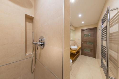 a bathroom with a shower and a toilet and a sink at Arca Superior in Cefalù