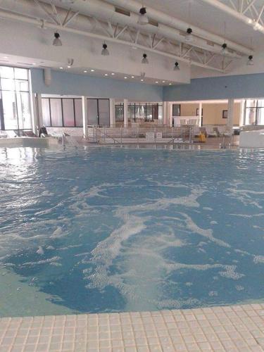 a swimming pool with blue water in a building at Apartmani Ramonda in Teslić