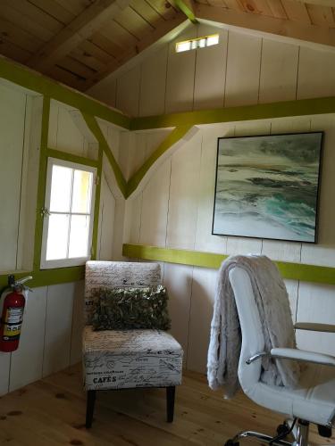 a room with a chair and a window in a house at Dreamers Writing Farm, 3 Wooded Acres, Hepworth in Sauble Beach