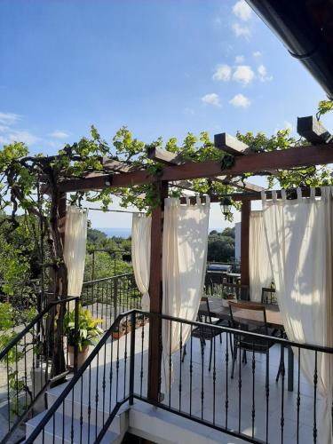 a pergola with white curtains on a balcony at Casa Nonna Tereza in Premantura