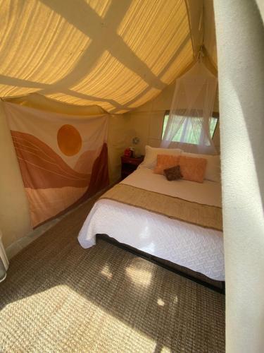 a bedroom with a bed in a tent at Dreamers Writing Farm, 3 Wooded Acres, Hepworth in Sauble Beach