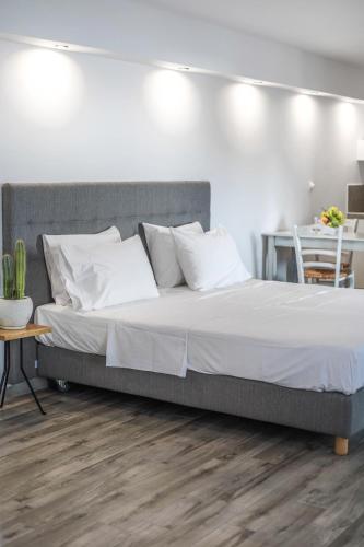 a bed with white sheets and pillows in a bedroom at Porto Kaza in Sitia