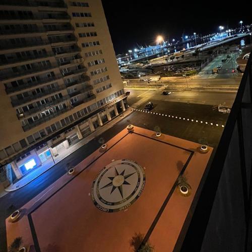 a clock on the side of a building at night at B&B D'Amari Affittacamere in Palermo