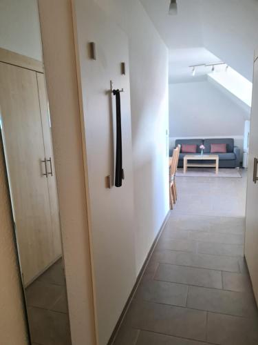 a hallway leading to a living room with a couch at Haus Hobbingshof Greetsiel in Greetsiel