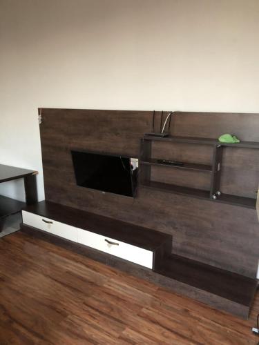 a living room with a large wooden entertainment center at HOTEL Dadu in Batumi