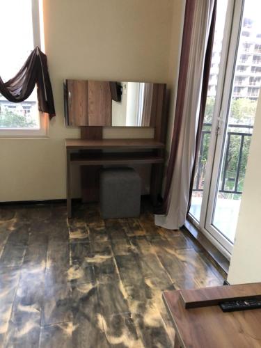 a room with a piano in a room with windows at HOTEL Dadu in Batumi