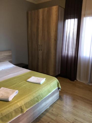 a bedroom with a bed with two towels on it at HOTEL Dadu in Batumi