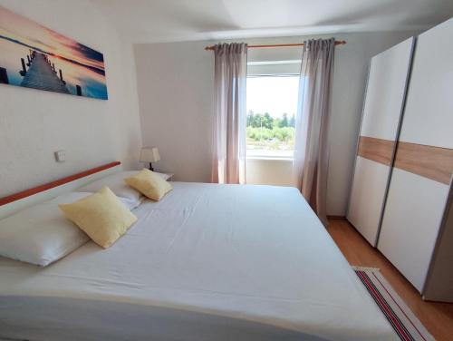 Postel nebo postele na pokoji v ubytování Kaštelina apartments