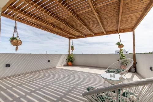 a patio with chairs and a table on a roof at Dorieus Villa in Lachania