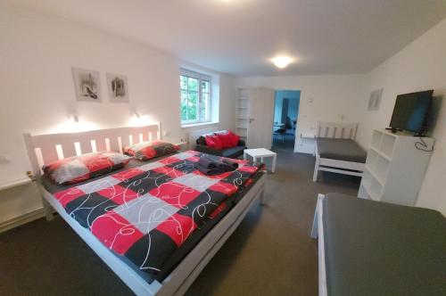 a bedroom with a bed and a living room at Apartmány Harrachov 288 in Harrachov
