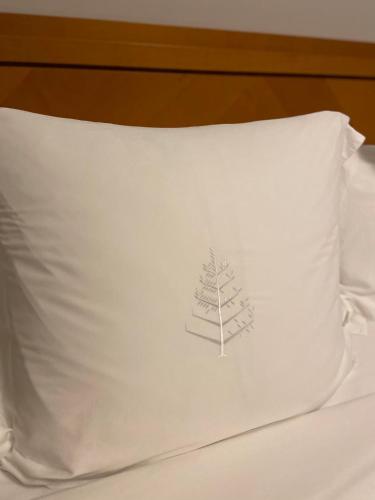 a pillow with a tree on it on a bed at Four Seasons Hotel Miami - Luxury Private Residences in Miami