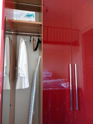 a red closet with a sliding glass door at Casa MiLù in Canneto