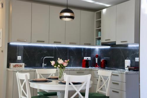 a kitchen with a table with chairs and a sink at Sunset View Stone House, Areopoli Mani in Areopolis