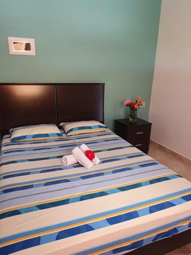 a bedroom with a bed with two towels on it at Chania Casa Portokali in Perivólia