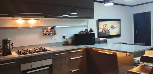 a kitchen with a stove and a counter top at 2Bedroom Luxury hotel apartment Fourways in Johannesburg