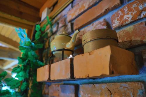 a brick wall with a pot on top of it at Apartment Green Lagoon in Bihać